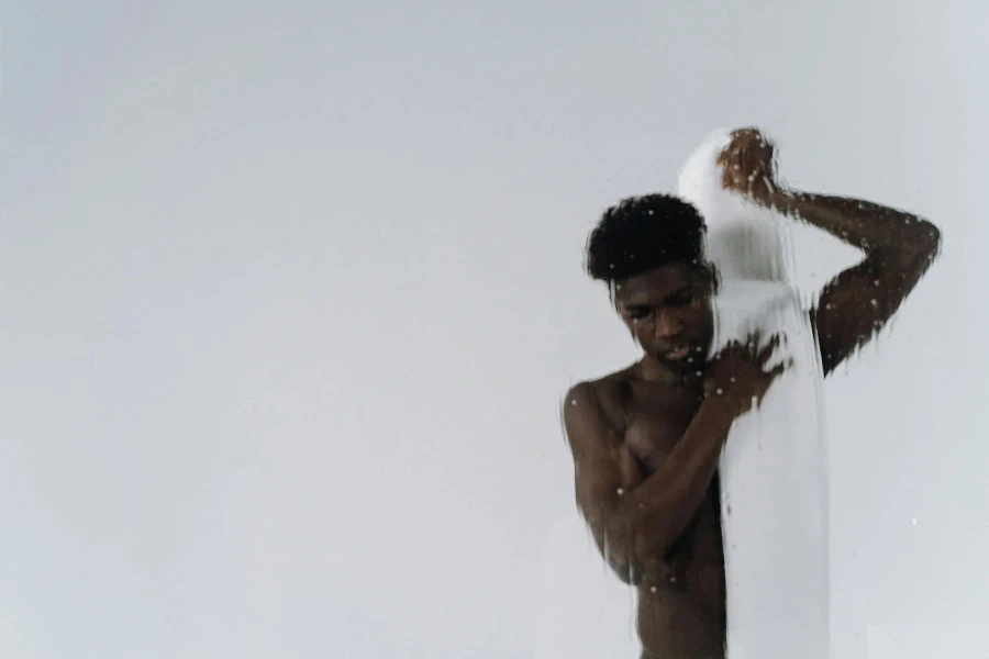 Shirtless Man Putting Towel on his Shoulder