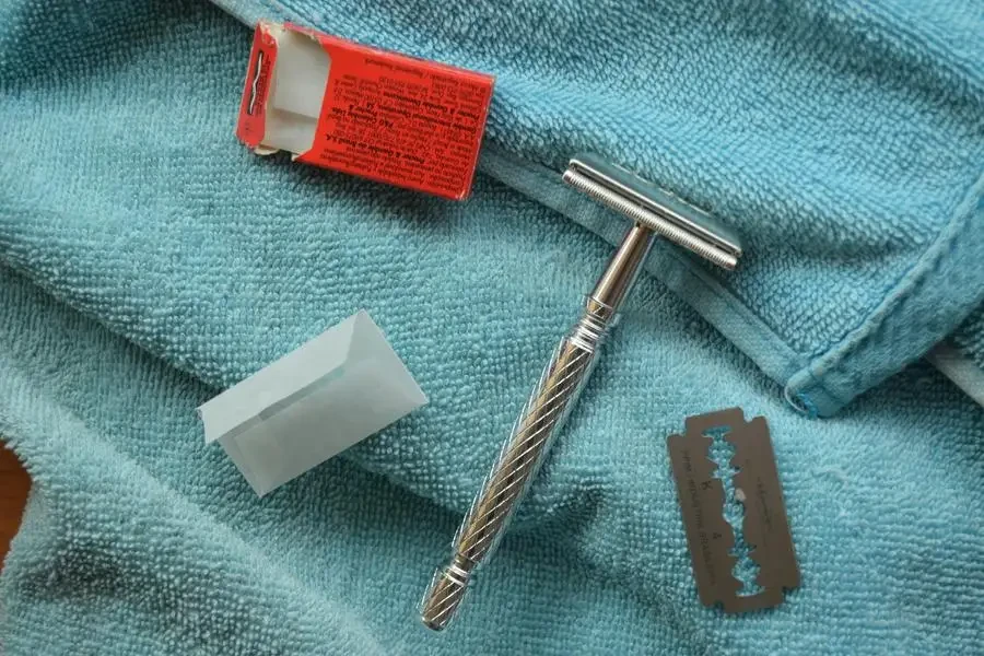 Silver Razor on Blue Bath Towel by Antonio Arcila