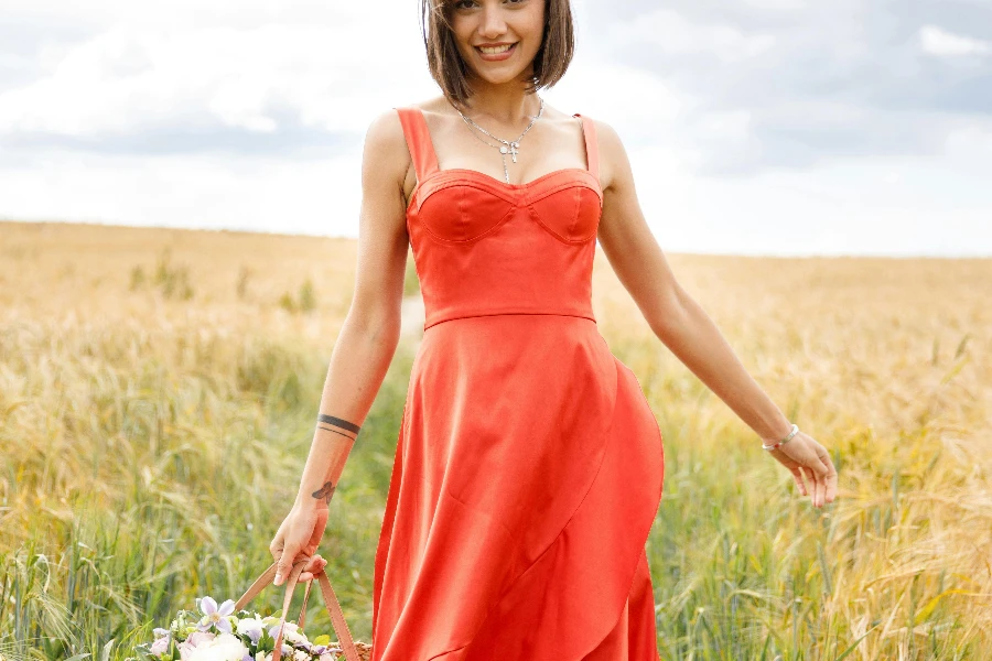 Smiling Young Woman Walking on the Meadow