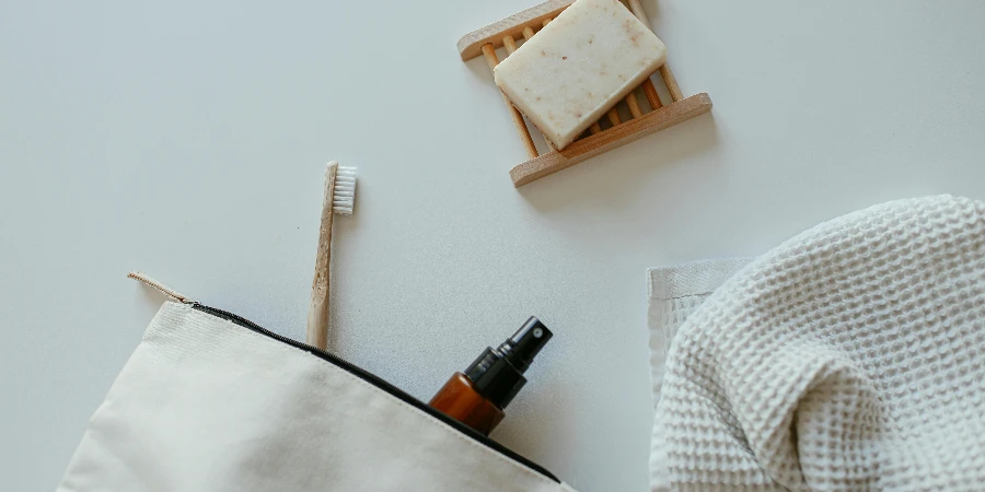 Soap, a Towel, a Toothbrush and a Spray Bottle in a Bag by Cup of Couple