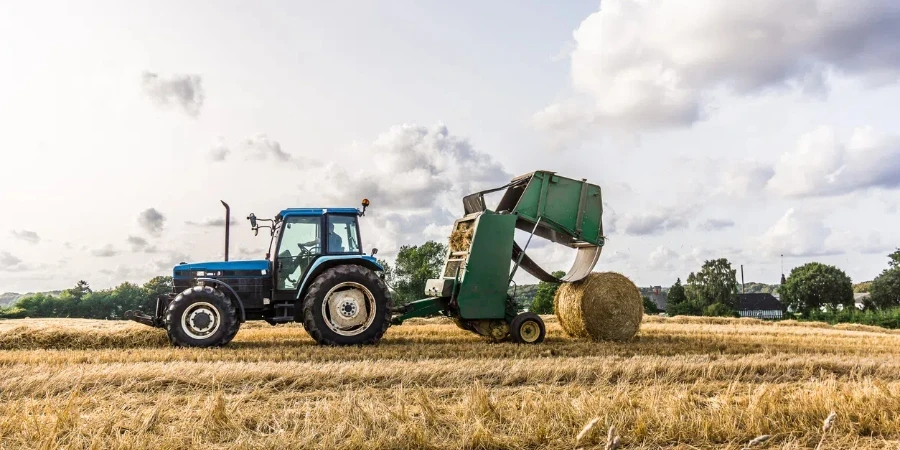 Straw Baling Machine after a tractor at work in a field