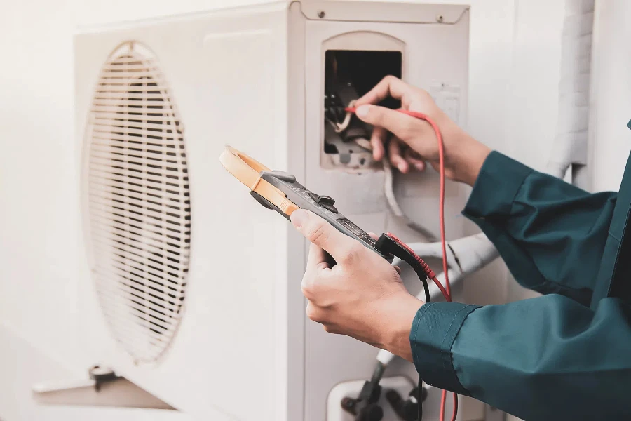 Technician checking the operation of the air conditioner