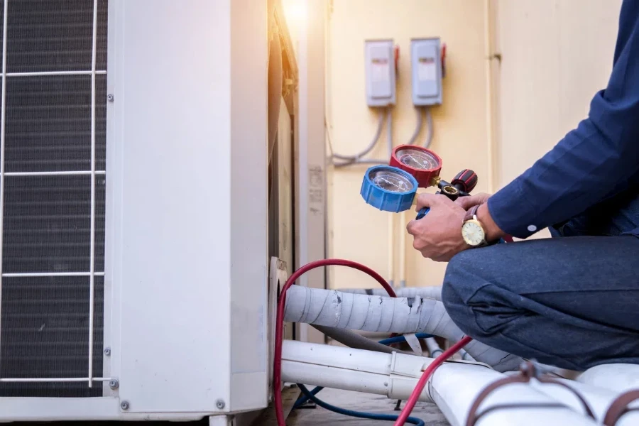 Technician is checking air conditioner ,measuring equipment for filling air conditioners