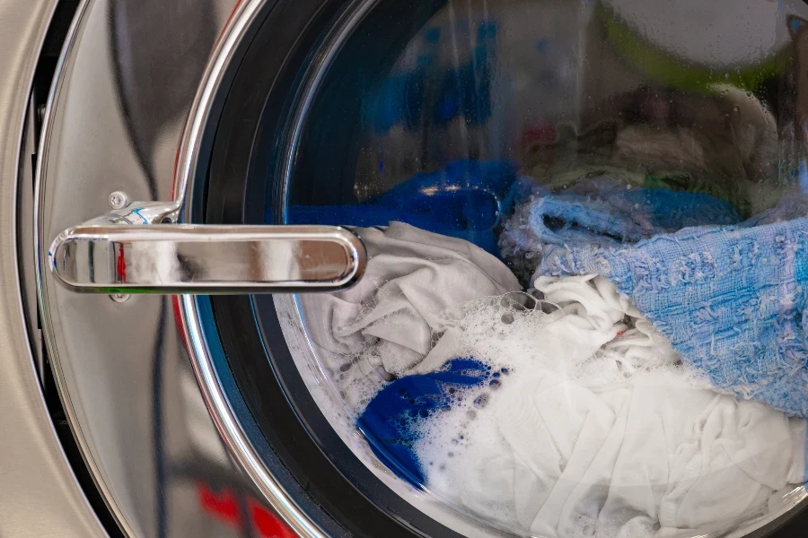 The washing machine is cleaning the clothes and washing away