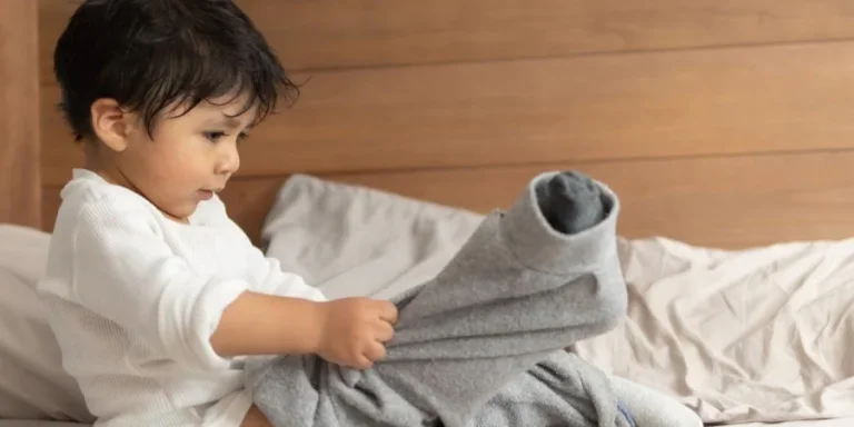 Toddler putting on clothes by themselves