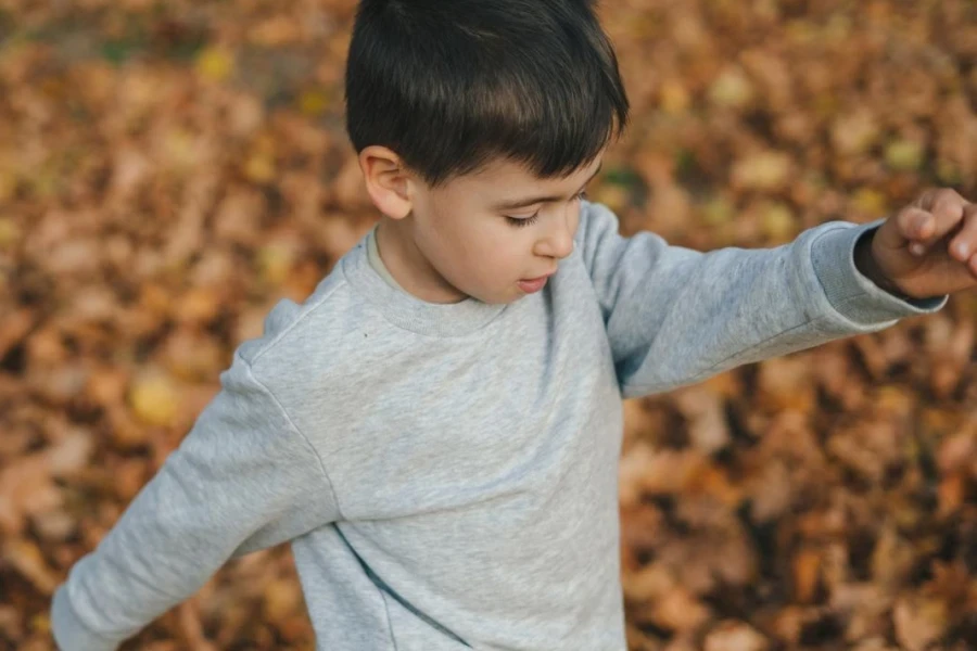 Trendy boy in long-sleeve tee for outdoor time