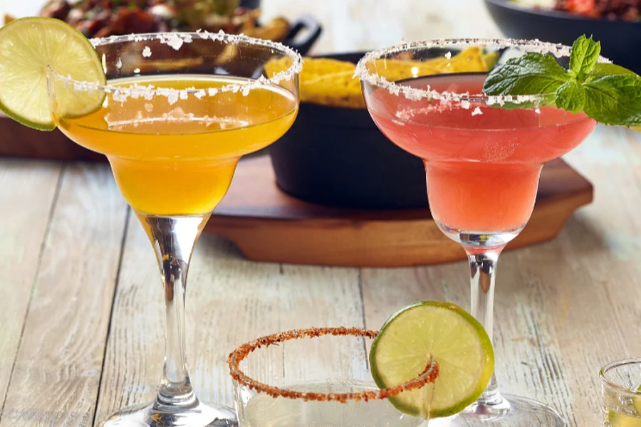 Two margaritas on a table with colored cocktails