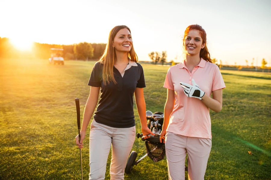 Two women walking on the golf coarse
