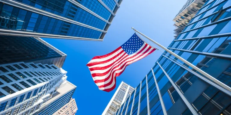 USA flag and contemporary glass skyscrapers in New York