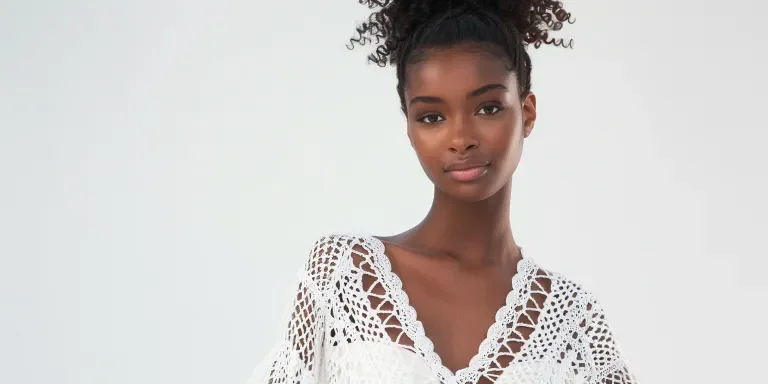 White crochet tunic with an open V-neckline
