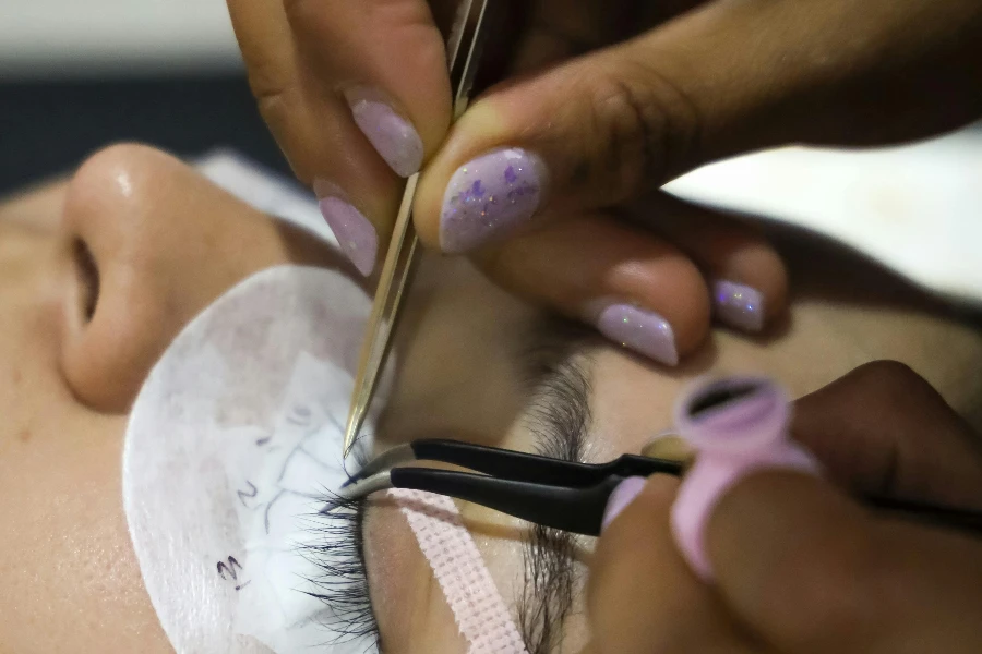 Woman Doing Lashes at Beautician