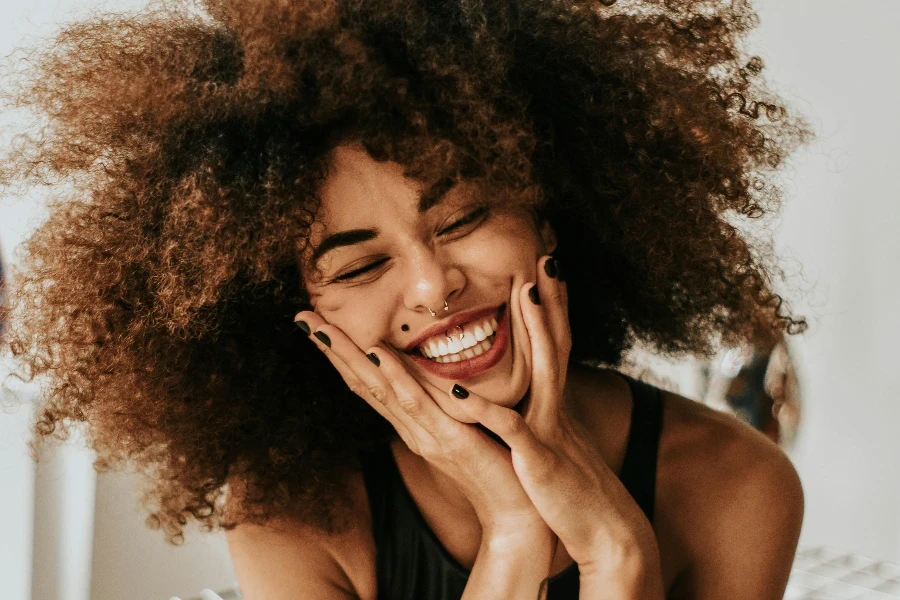 Woman Sitting And Smiling by Guilherme Almeida