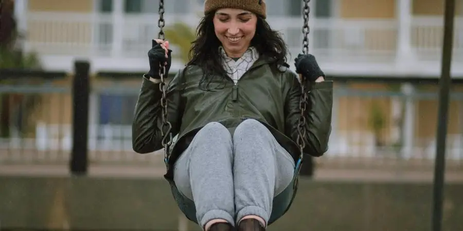 Woman Swinging on Swing by Josh Hild