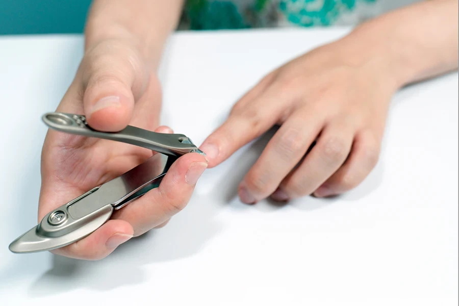 Woman cutting nail.