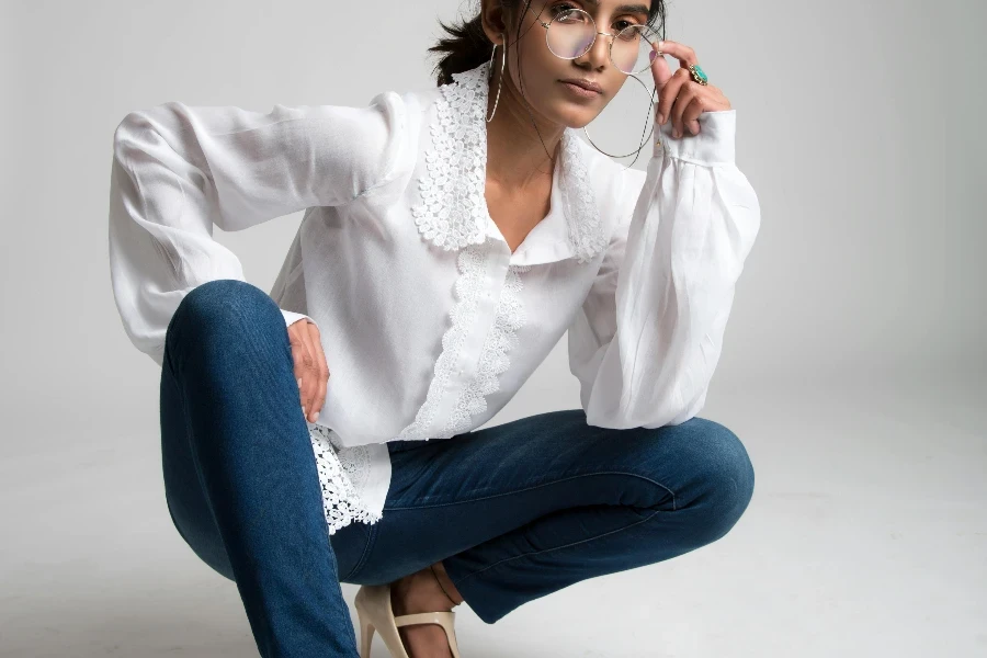 Woman in White Long Sleeve Shirt and Blue Denim Jeans