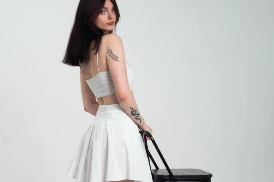 Woman in White Skirt Posing with Black Chair