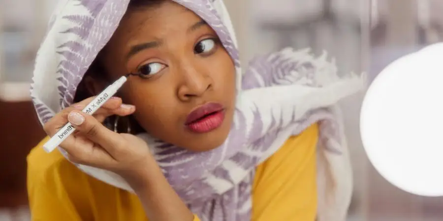 Woman in White and Purple Hijab Holding an Eyeliner by RDNE Stock project