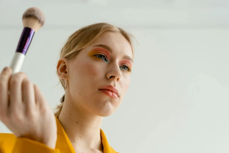 Woman in Yellow Collared Shirt Holding a Brush