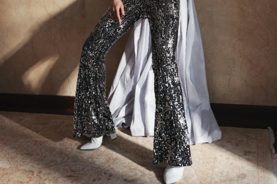 Woman in silver sequin flare pants