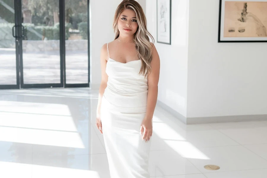 Woman in white satin midi dress