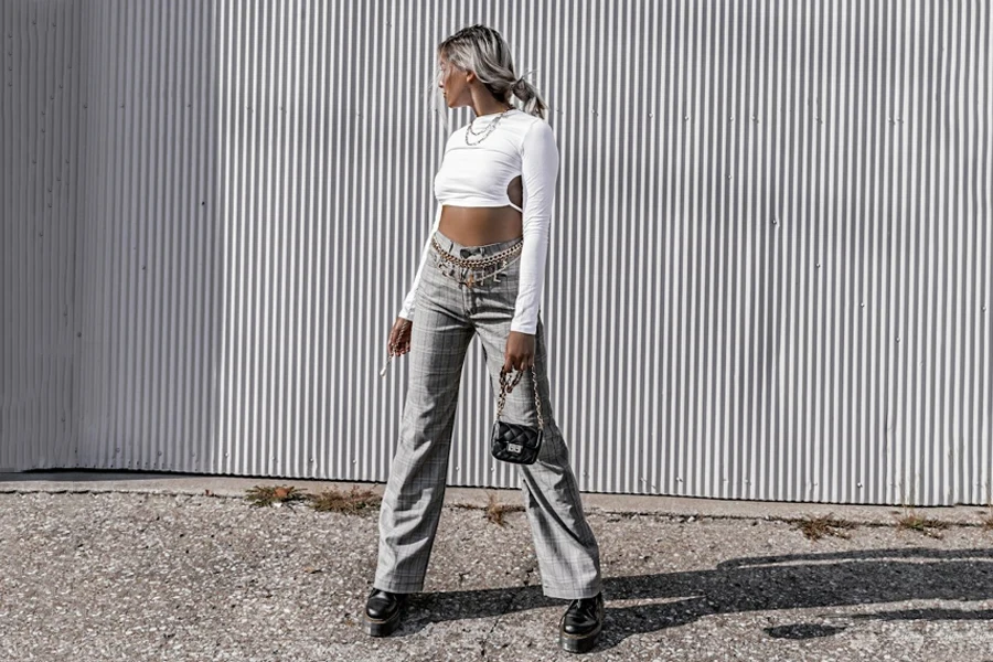 Woman wearing gray plaid high rise flare trousers