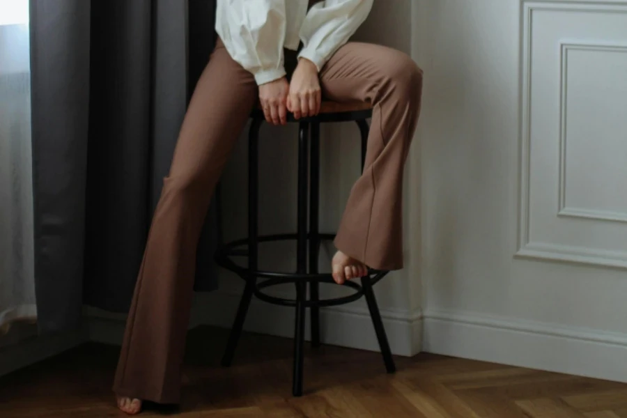 Woman wearing tan flared trousers