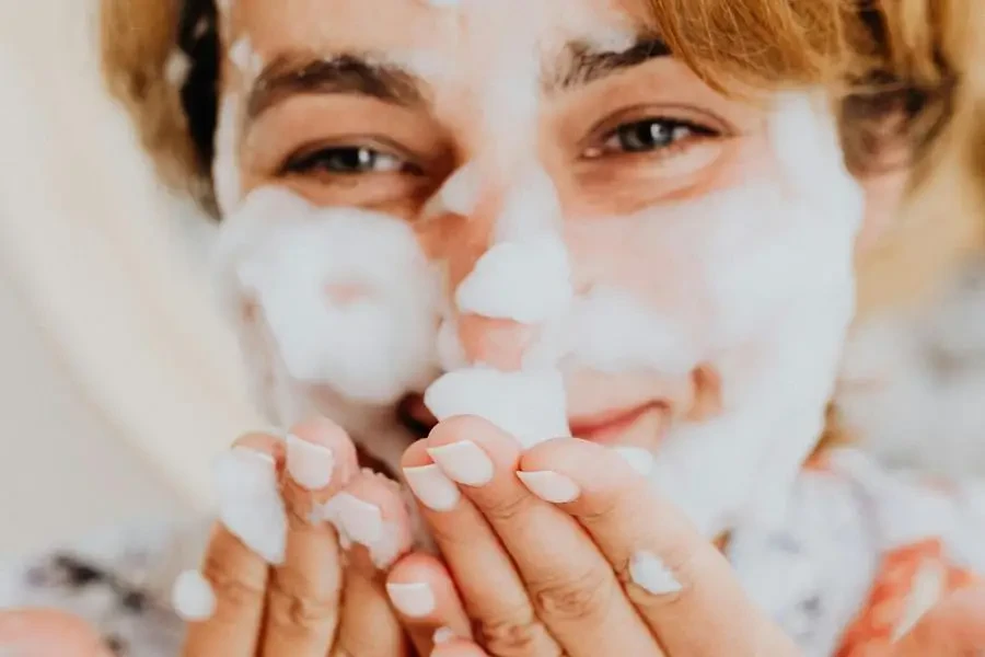 Woman with a Bubble Face Mask Smiling by Karolina Kaboompics