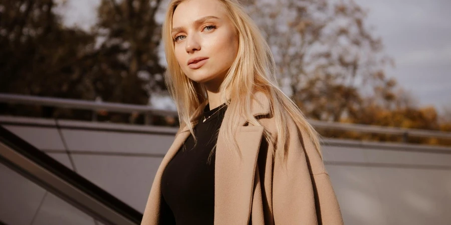 Young Woman Standing on the Stairs and Leaning on the Railing