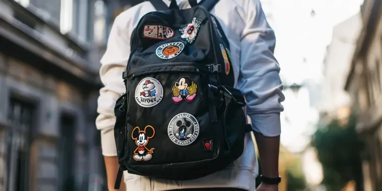 a black backpack with school patches