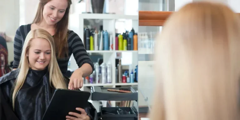 A hairdresser attending to a happy client