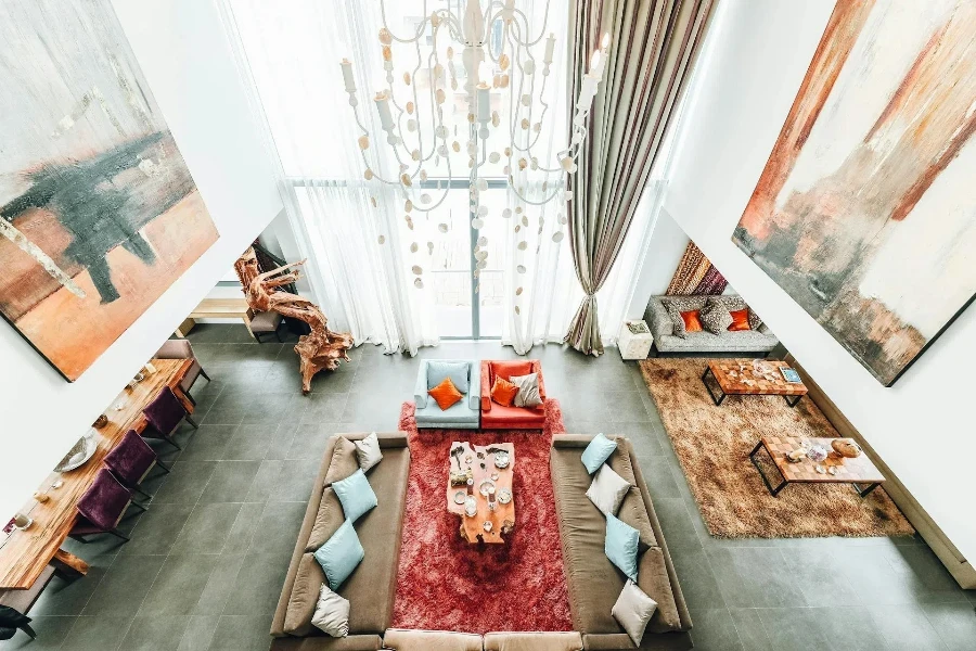 A living room with open space and rugs