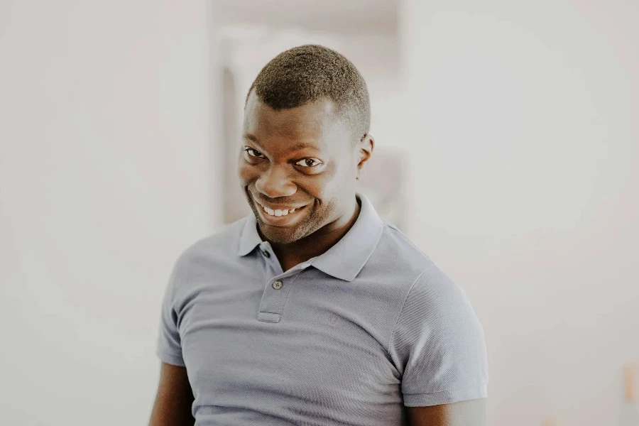 A man wearing a gray polo shirt