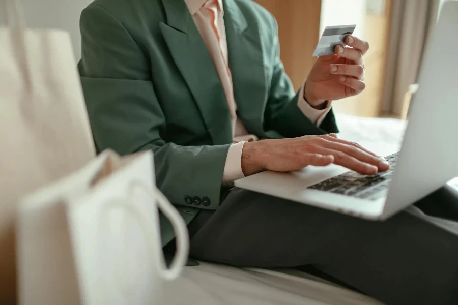 A person entering card details in a laptop