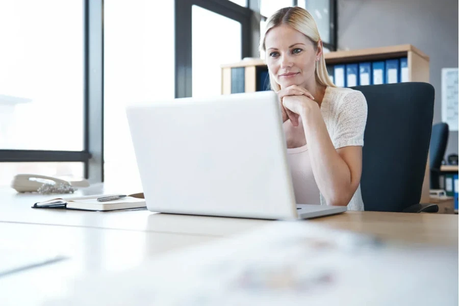 A woman staring intently at her laptop