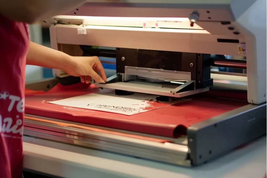 A person is using a screen printer