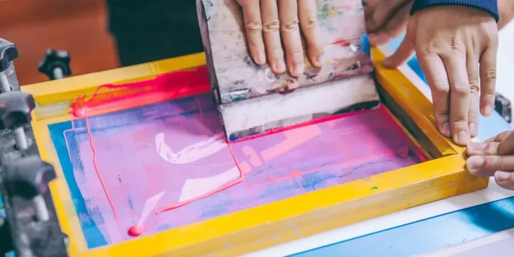 an art student is working on some silk screens