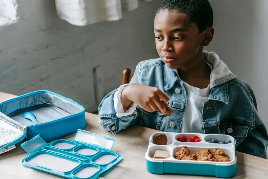 Boy eating from a lunch box