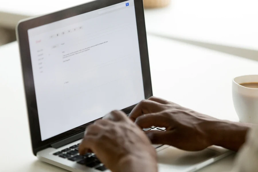 businessman typing email on a laptop