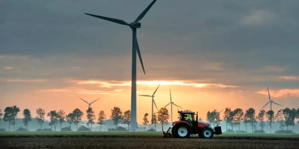 group of wind mills in the fog at sunrise