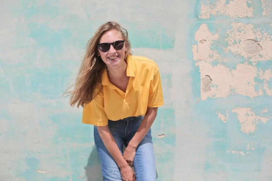 Happy woman wearing denim trousers and a polo shirt