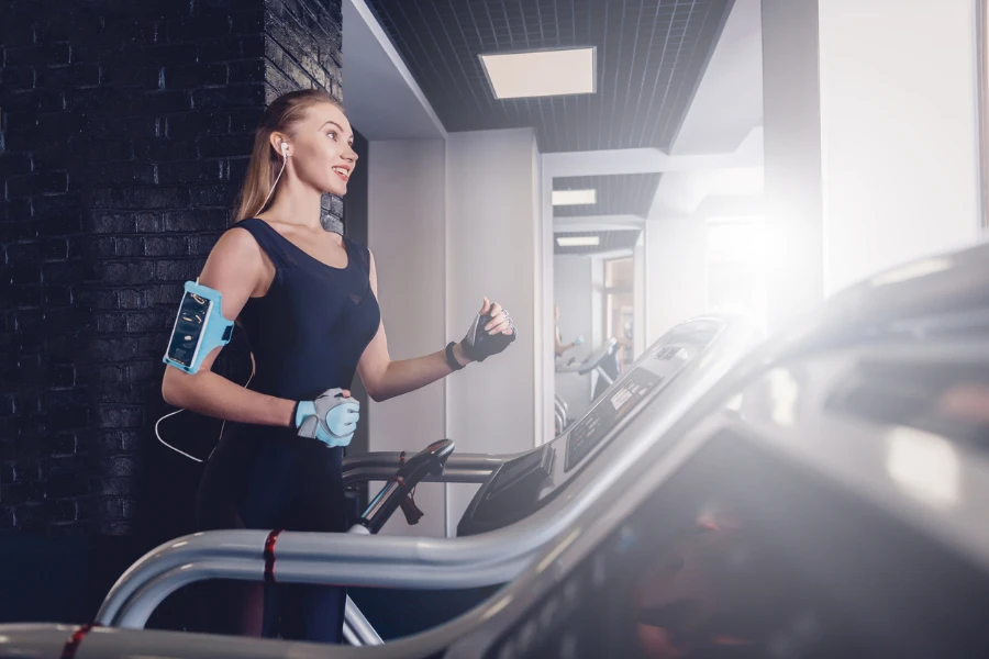 Happy women jogging on a treadmill