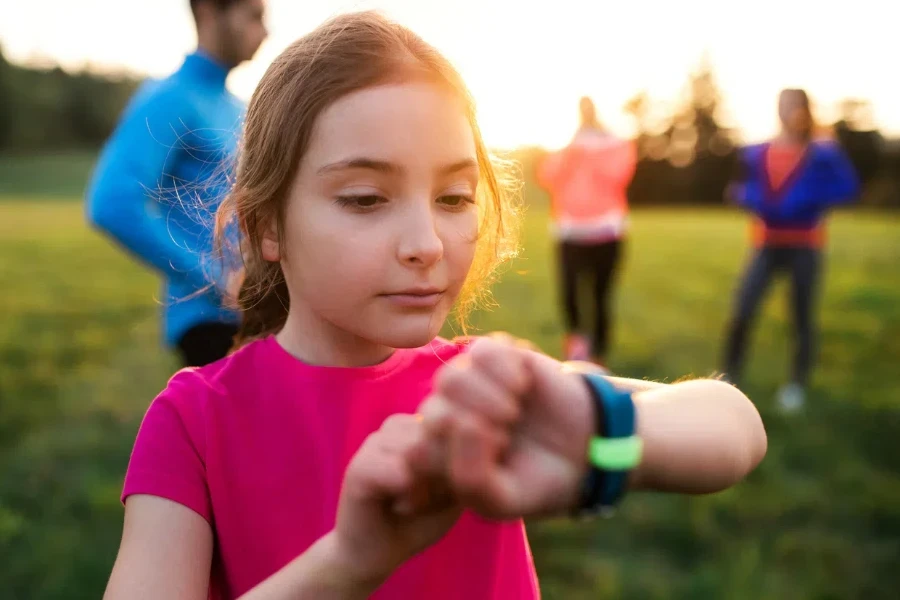 small girl with large group of people doing exercise