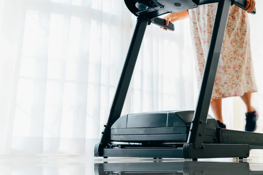 Grandmother running on a treadmill at home