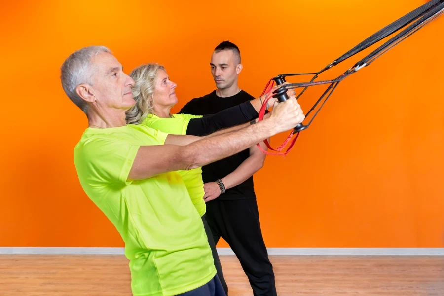 senior fit couple doing elastic band