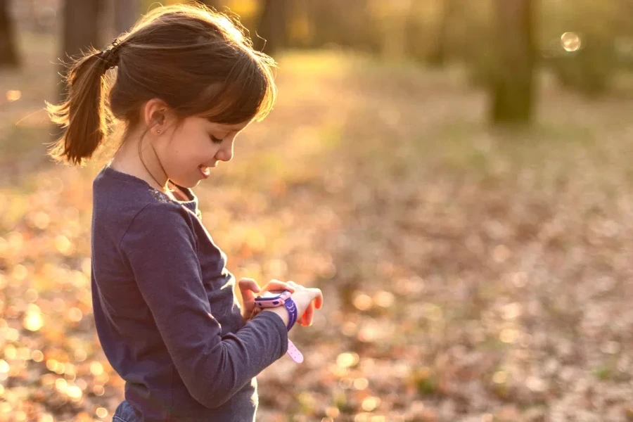 happy girl using smart watch in nature