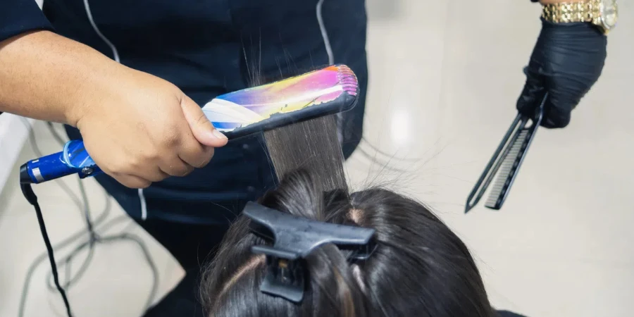 top shot of a woman straightening the hair