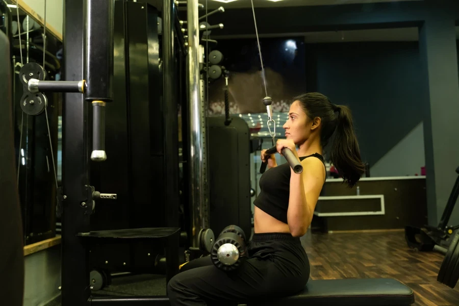 Sporty Indian girl doing lat pull