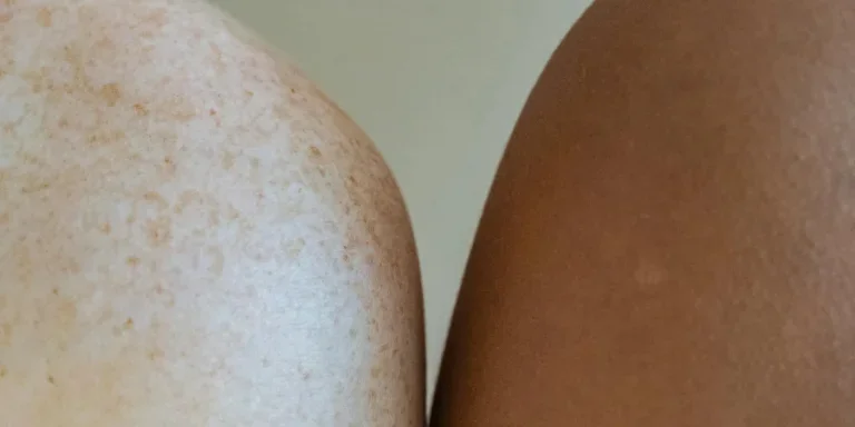Shoulders of multiracial models against light wall