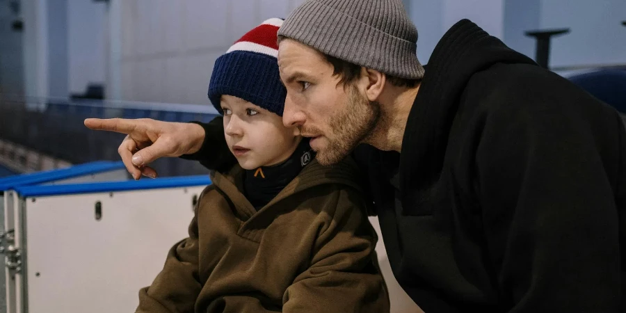 Father and Son in Hats and Jacket at Ice Rink