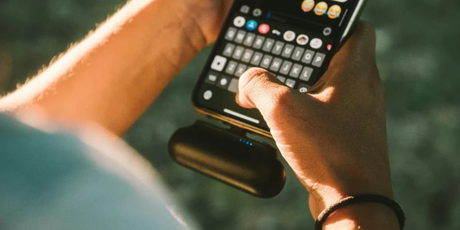 Person Holding Black Qwerty Phone